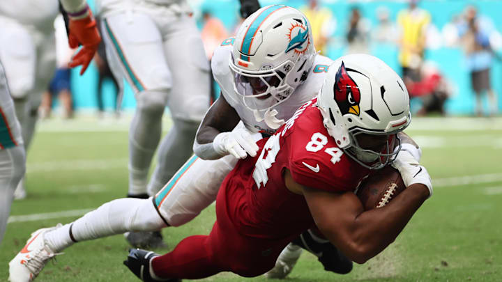 Oct 27, 2024; Miami Gardens, Florida, USA; Arizona Cardinals tight end Elijah Higgins (84) is tackled short of the goal line by Miami Dolphins safety Jevon Holland (8) during the second quarter at Hard Rock Stadium. 