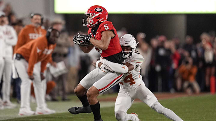 Texas Longhorns defensive back Warren Roberson tackles Georgia Bulldogs wide receiver Noah Thomas