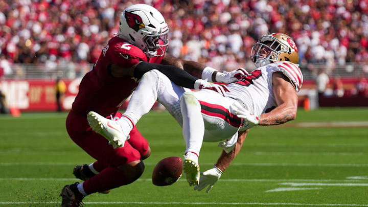 Arizona Cardinals linebacker Mack Wilson (2) puts the hit on San Francisco 49ers running back Christian McCaffrey (23).
