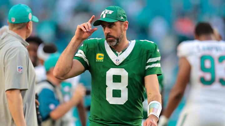 Dec 8, 2024; Miami Gardens, Florida, USA; New York Jets quarterback Aaron Rodgers (8) reacts from the field after the game against the Miami Dolphins at Hard Rock Stadium. Mandatory Credit: Sam Navarro-Imagn Images