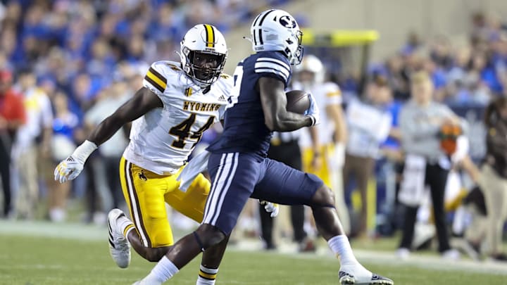 Sep 24, 2022; Provo, Utah, USA; Wyoming Cowboys defensive end Oluwaseyi Omotosho (44) defends as Brigham Young Cougars running back Miles Davis (19) after makes a catch in the first quarter at LaVell Edwards Stadium. Mandatory Credit: Rob Gray-Imagn Images