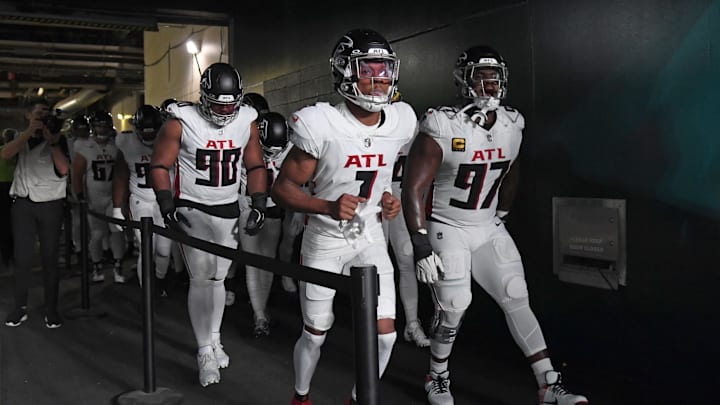 Sep 16, 2024; Philadelphia, Pennsylvania, USA; Atlanta Falcons defensive tackle David Onyemata (90), wide receiver Darnell Mooney (1) and defensive end Grady Jarrett (97) lead the team onto the field against the Philadelphia Eagles at Lincoln Financial Field. Mandatory Credit: Eric Hartline-Imagn Images