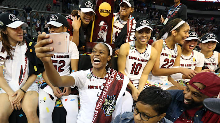 Former South Carolina basketball star Kaela Davis posing with the National Championship trophy