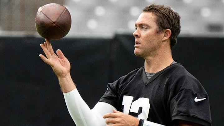 QB Colt McCoy spins a football during training camp at State Farm Stadium in Glendale on July 31,