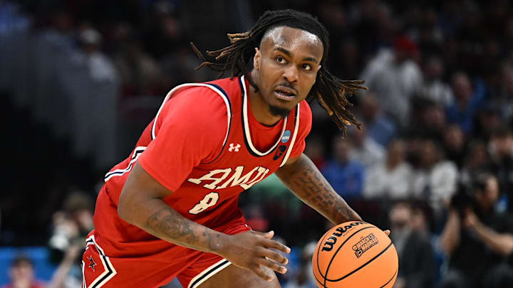 Mar 21, 2025; Cleveland, OH, USA; Robert Morris Colonials guard Kam Woods (8) dribbles in the second half against the Alabama Crimson Tide during the NCAA Tournament First Round at Rocket Arena. Mandatory Credit: Ken Blaze-Imagn Images