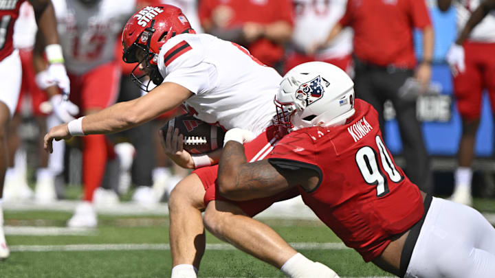 Sep 7, 2024; Louisville, Kentucky, USA;  Louisville Cardinals defensive lineman Rene Konga (90) sacks Jacksonville State Gamecocks quarterback Tyler Huff (6) during the first quarter at L&N Federal Credit Union Stadium. Mandatory Credit: Jamie Rhodes-Imagn Images