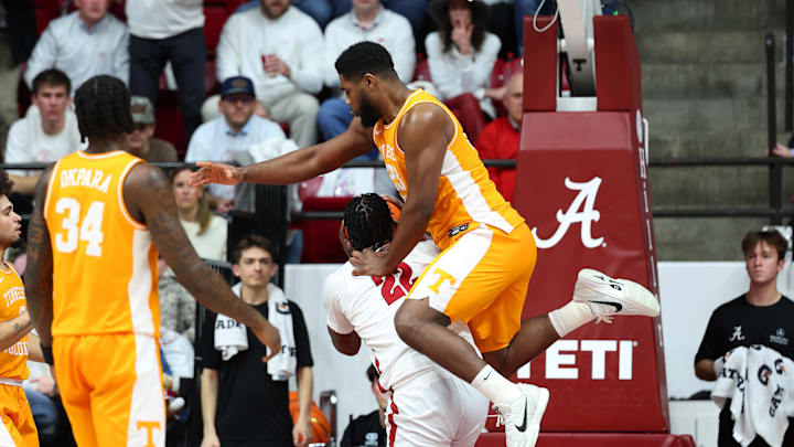 Jan 24, 2026; Tuscaloosa, Alabama, USA; Tennessee Volunteers forward Jaylen Carey (23) falls on top of Alabama Crimson Tide forward Aiden Sherrell (22) during the first half at Coleman Coliseum. Mandatory Credit: David Leong-Imagn Images