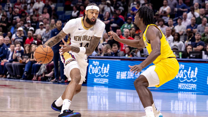 Nov 1, 2024; New Orleans, Louisiana, USA;  New Orleans Pelicans forward Brandon Ingram (14) dribbles against Indiana Pacers forward Aaron Nesmith (23) during the first half at Smoothie King Center. Mandatory Credit: Stephen Lew-Imagn Images