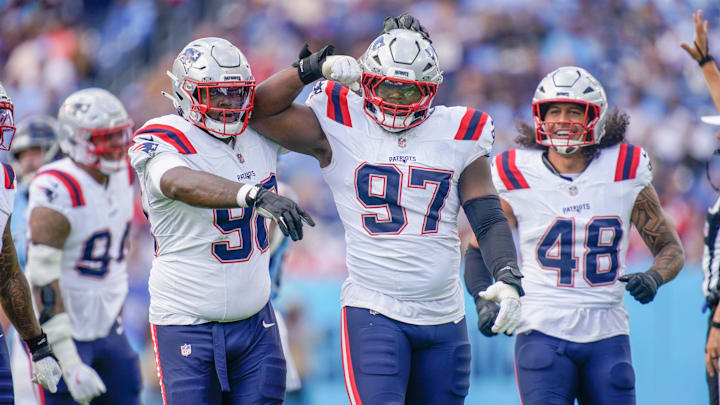 New England Patriots defensive end Milton Williams (97) celebrates sacking Tennessee Titans quarterback Cam Ward (1) during the third quarter at Nissan Stadium in Nashville, Tenn., Sunday, Oct. 19, 2025.