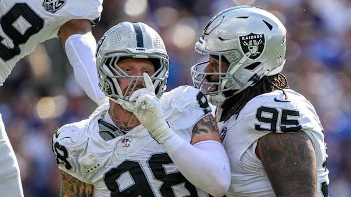 Sep 15, 2024; Baltimore, Maryland, USA; Las Vegas Raiders defensive end Maxx Crosby (98) celebrates with defensive tackle John Jenkins (95) after sacking Baltimore Ravens quarterback Lamar Jackson (not pictured) during the second half at M&T Bank Stadium. Mandatory Credit: Reggie Hildred-Imagn Images