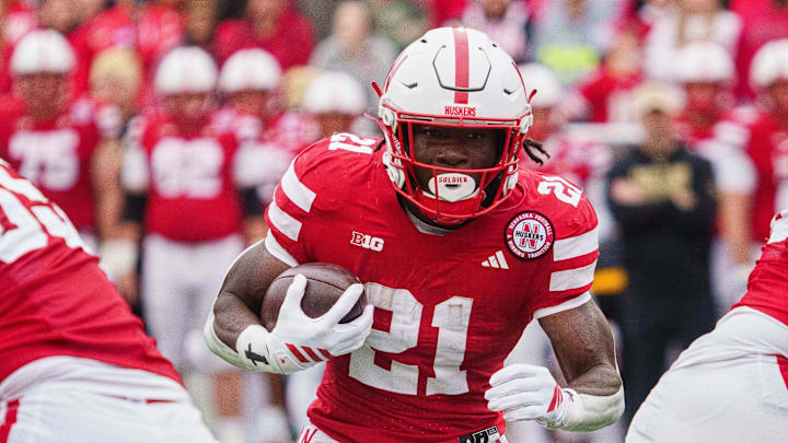 Oct 25, 2025; Lincoln, Nebraska, USA; Nebraska Cornhuskers running back Emmett Johnson (21) runs the ball against the Northwestern Wildcats during the first quarter at Memorial Stadium. Mandatory Credit: Dylan Widger-Imagn Images
