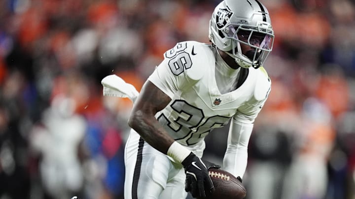 Nov 6, 2025; Denver, Colorado, USA; Las Vegas Raiders cornerback Kyu Blu Kelly (36) intercepts a pass against the Denver Broncos during the first half at Empower Field at Mile High. Mandatory Credit: Ron Chenoy-Imagn Images