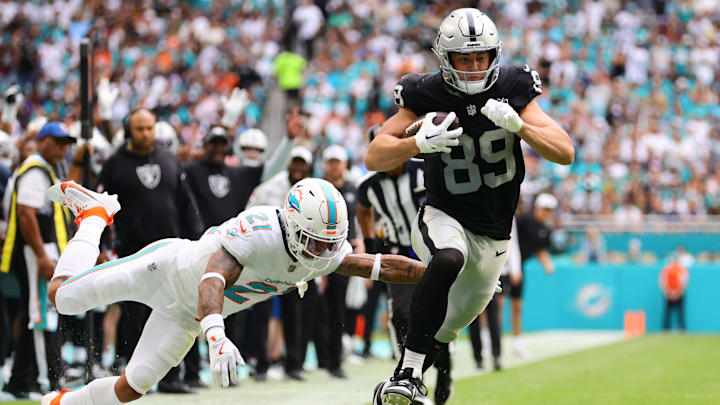 Las Vegas Raiders tight end Brock Bowers (89) runs with the football past Miami Dolphins safety Jordan Poyer (21) during the third quarter at Hard Rock Stadium. Las Vegas Raiders tight end Brock Bowers (89) runs with the football past Miami Dolphins safety Jordan Poyer (21) during the third quarter at Hard Rock Stadium.