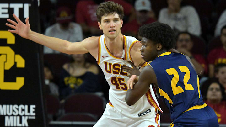Dec 21, 2025; Los Angeles, California, USA; USC Trojans center Gabe Dynes (45) is defended by UC Santa Cruz Banana Slugs guard Teni SalakoChase Rawlins (22) in the second half at Galen Center. Mandatory Credit: Jayne Kamin-Oncea-Imagn Images