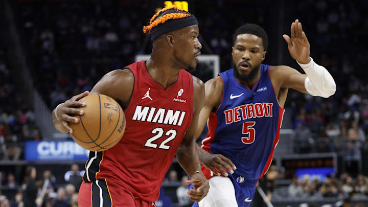 Dec 16, 2024; Detroit, Michigan, USA;  Miami Heat forward Jimmy Butler (22) dribbles as Detroit Pistons guard Malik Beasley (5) defends in the first half at Little Caesars Arena. Mandatory Credit: Rick Osentoski-Imagn Images