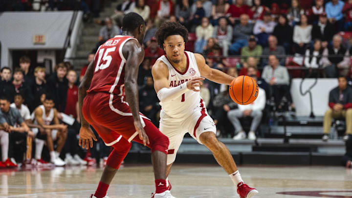 Jan 4, 2025; Tuscaloosa, Alabama, USA; Alabama Crimson Tide guard Mark Sears (1) drives against Oklahoma Sooners guard Duke Miles (15) during the first half at Coleman Coliseum. Mandatory Credit: Will McLelland-Imagn Images