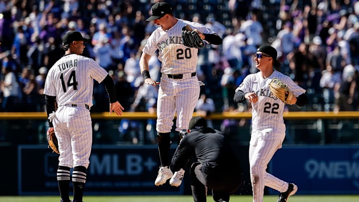 Apr 19, 2026; Denver, Colorado, USA; Colorado Rockies right fielder Troy Johnston (20) celebrates with shortstop Ezequiel Tovar (14) and left fielder Mickey Moniak (22) after the game against the Los Angeles Dodgers at Coors Field. 
