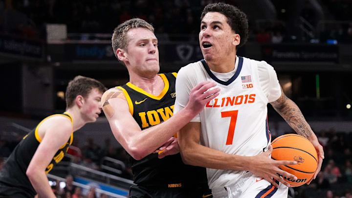 Illinois Fighting Illini forward Will Riley (7) rushes past Iowa Hawkeyes forward Payton Sandfort (20) on Thursday, March 13, 2025, during the second round of the men's Big Ten tournament at Gainbridge Fieldhouse in Indianapolis. The Illinois Fighting Illini defeated the Iowa Hawkeyes, 106-94. Illinois Fighting Illini forward Will Riley (7) rushes past Iowa Hawkeyes forward Payton Sandfort (20) on Thursday, March 13, 2025, during the second round of the men's Big Ten tournament at Gainbridge Fieldhouse in Indianapolis. The Illinois Fighting Illini defeated the Iowa Hawkeyes, 106-94.