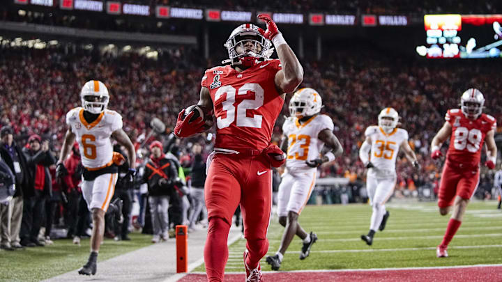 Ohio State Buckeyes running back TreVeyon Henderson (32) runs for a touchdown during the first half of the College Football Playoff first round game against the Tennessee Volunteers at Ohio Stadium in Columbus on Dec. 21, 2024.