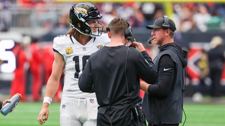 Nov 9, 2025; Houston, Texas, USA; Jacksonville Jaguars quarterback Trevor Lawrence (16) talks with head coach Liam Coen during the first half of a game against the Houston Texans at NRG Stadium. Mandatory Credit: Thomas Shea-Imagn Images