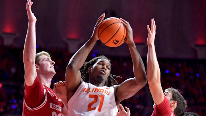 Dec 10, 2024; Champaign, Illinois, USA; Illinois Fighting Illini forward Morez Johnson Jr. (21) pulls a rebound as Wisconsin Badgers forward Steven Crowl (22) and teammates defend during the first half at State Farm Center. Mandatory Credit: Ron Johnson-Imagn Images Dec 10, 2024; Champaign, Illinois, USA; Illinois Fighting Illini forward Morez Johnson Jr. (21) pulls a rebound as Wisconsin Badgers forward Steven Crowl (22) and teammates defend during the first half at State Farm Center. Mandatory Credit: Ron Johnson-Imagn Images