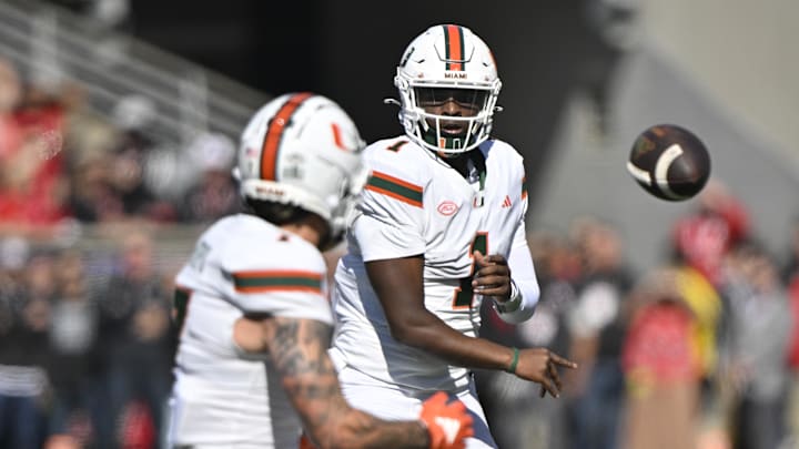 Oct 19, 2024; Louisville, Kentucky, USA; Miami Hurricanes quarterback Cam Ward (1) passes to wide receiver Xavier Restrepo (7) against the Louisville Cardinals during the first quarter at L&N Federal Credit Union Stadium. Mandatory Credit: Jamie Rhodes-Imagn Images
