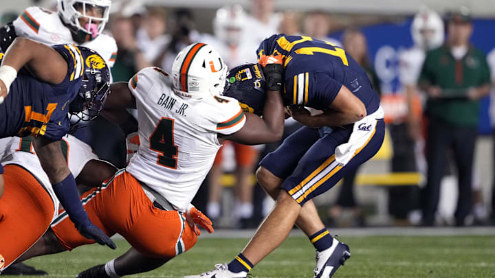 Oct 5, 2024; Berkeley, California, USA; Miami Hurricanes defensive lineman Rueben Bain Jr. (4) sacks California Golden Bears quarterback Fernando Mendoza (right) during the fourth quarter at California Memorial Stadium. Mandatory Credit: Darren Yamashita-Imagn Images