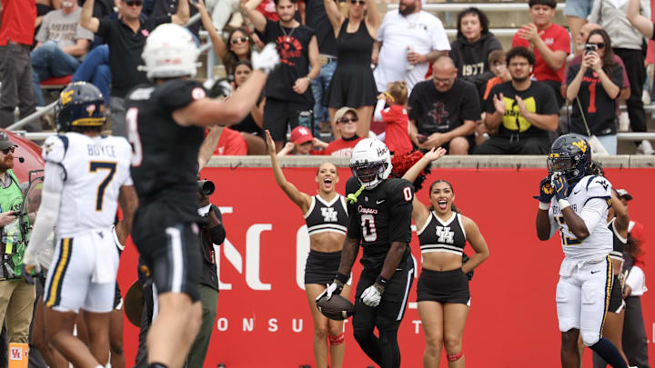 Nov 1, 2025; Houston, Texas, USA;  Houston Cougars wide receiver Amare Thomas (0) celebrates his touchdown against the West Virginia Mountaineers in the first half at TDECU Stadium. Mandatory Credit: Thomas Shea-Imagn Images
