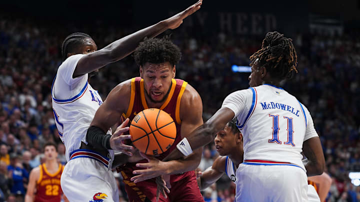 Jan 13, 2026; Lawrence, Kansas, USA; Iowa State Cyclones forward Joshua Jefferson (5) loses control of the ball while driving against Kansas Jayhawks forward Flory Bidunga (40) and guard Jamari McDowell (11) during the first half at Allen Fieldhouse.