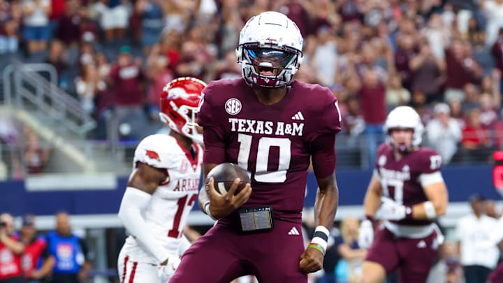 Sep 28, 2024; Arlington, Texas, USA;  Texas A&M Aggies quarterback Marcel Reed (10) reacts after scoring a touchdown during the first half against the Arkansas Razorbacks at AT&T Stadium. Mandatory Credit: Kevin Jairaj-Imagn Images