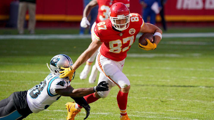 Nov 8, 2020; Kansas City, Missouri, USA; Kansas City Chiefs tight end Travis Kelce (87) runs the ball against Carolina Panthers defensive back Myles Hartsfield (38) during the first half at Arrowhead Stadium. Mandatory Credit: Denny Medley-Imagn Images