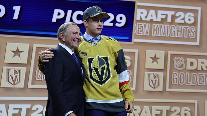 Jun 26, 2026; Buffalo, New York, USA; Juho Piiparinen reacts beside NHL commissioner Gary Bettman after being selected with the twenty ninth pick in the first round of the 2026 NHL Draft by the Vegas Golden Knights at KeyBank Center. Mandatory Credit: Timothy T. Ludwig-Imagn Images