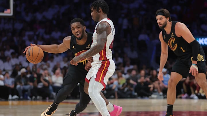 Apr 28, 2025; Miami, Florida, USA; Cleveland Cavaliers guard Donovan Mitchell (45) drives the basketball against Miami Heat guard Davion Mitchell (45) in the second quarter during game four for the first round of the 2025 NBA Playoffs at Kaseya Center. Mandatory Credit: Sam Navarro-Imagn Images