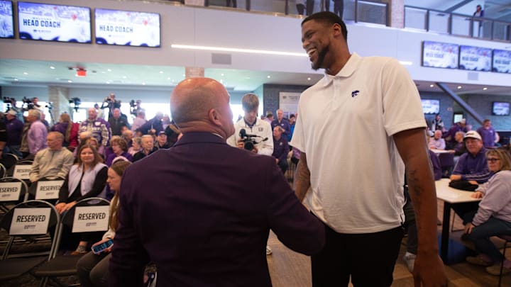 Casey Alexander shakes hand with former player Jordan Henriquez after being welcomed as the new head coach of the Kansas State men’s basketball team during a press conference at Bramlage Coliseum on Monday, March 16, 2026.