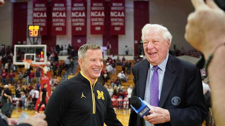 Feb 8, 2025; Bloomington, Indiana, USA; Michigan Wolverines head coach Dusty May talks to CBS broadcaster Bill Raftery after the game Indiana Hoosiers at Simon Skjodt Assembly Hall. Mandatory Credit: Robert Goddin-Imagn Images