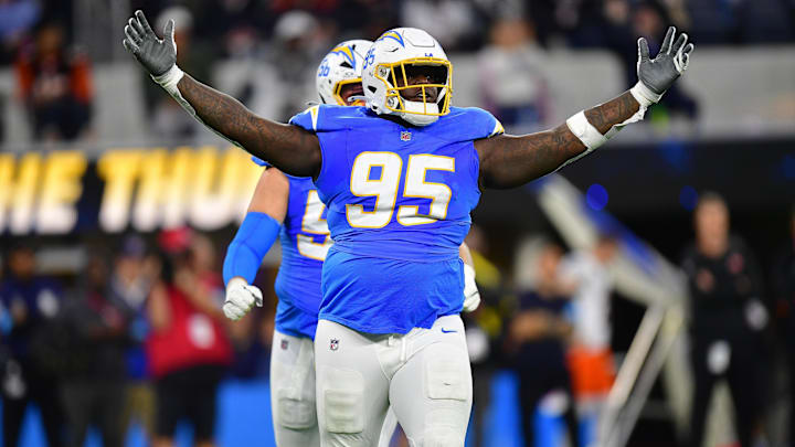 Nov 17, 2024; Inglewood, California, USA; Los Angeles Chargers defensive tackle Poona Ford (95) reacts after sacking Cincinnati Bengals quarterback Joe Burrow (9) during the first half at SoFi Stadium. Mandatory Credit: Gary A. Vasquez-Imagn Images