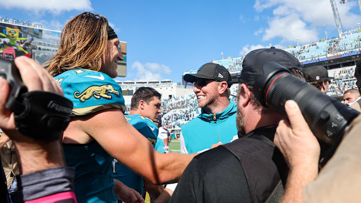Sep 21, 2025; Jacksonville, Florida, USA; Jacksonville Jaguars head coach Liam Coen and quarterback Trevor Lawrence (16) shake hands after the game at EverBank Stadium. Mandatory Credit: Morgan Tencza-Imagn Images