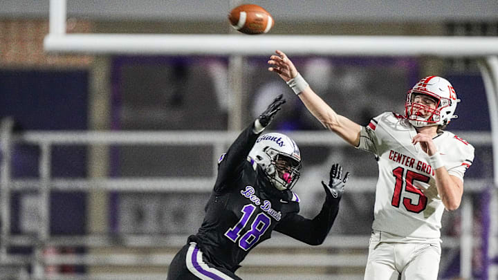 Center Grove Trojans quarterback Tyler Cherry (15) throws the ball against Ben Davis Giants Frank