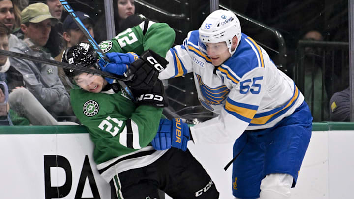 Jan 23, 2026; Dallas, Texas, USA; St. Louis Blues defenseman Colton Parayko (55) checks Dallas Stars left wing Jason Robertson (21) during the first period at the American Airlines Center. Mandatory Credit: Jerome Miron-Imagn Images