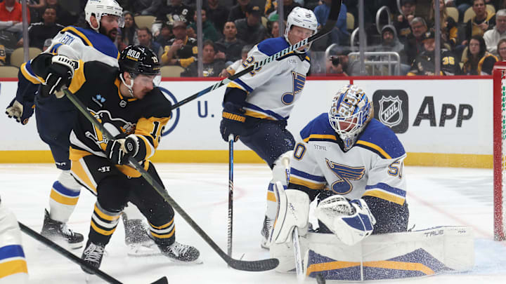 Mar 13, 2025; Pittsburgh, Pennsylvania, USA;  St. Louis Blues goaltender Jordan Binnington (50) makes a save against Pittsburgh Penguins center Connor Dewar (19) during the third period at PPG Paints Arena. Mandatory Credit: Charles LeClaire-Imagn Images