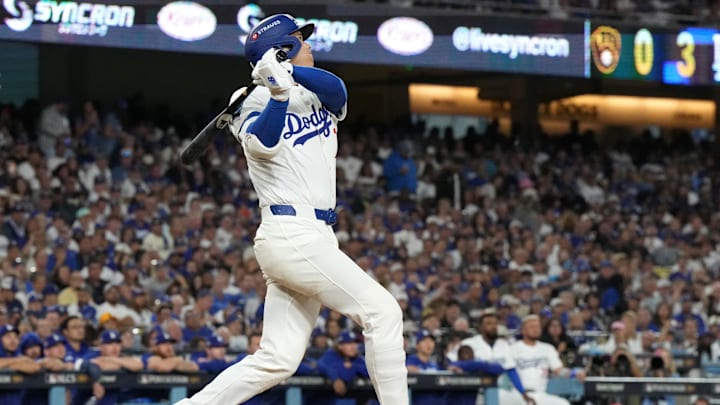 Oct 17, 2025; Los Angeles, California, USA; Los Angeles Dodgers two-way player Shohei Ohtani (17) hits a solo home run against the Milwaukee Brewers in the fourth inning during game four of the NLCS round for the 2025 MLB playoffs at Dodger Stadium. Mandatory Credit: Kirby Lee-Imagn Images