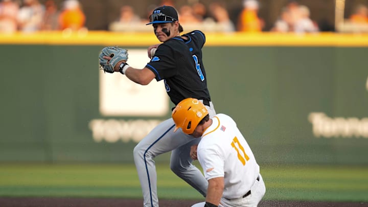 Kentucky infielder Tyler Bell (6) throws the ball to first base after getting Tennessee infielder Andrew Fischer (11) out at second base during a NCAA baseball game between Tennessee and Kentucky at Lindsey Nelson Stadium in Knoxville, Tenn., on April 18, 2025.