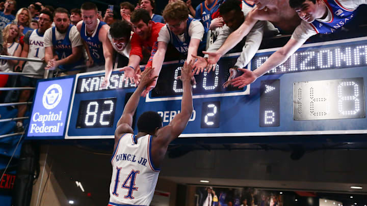 Kansas Jayhawks guard Melvin Council Jr. (14) slaps hands with fans after defeating Arizona Wildcats 82-78 in the game inside Allen Fieldhouse on Feb. 9, 2026.