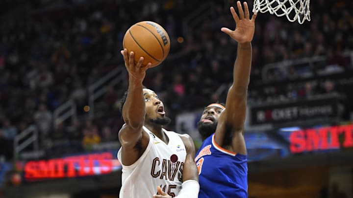 Oct 30, 2022; Cleveland, Ohio, USA; Cleveland Cavaliers guard Donovan Mitchell (45) drives against New York Knicks center Mitchell Robinson (23) in the fourth quarter at Rocket Mortgage FieldHouse. Mandatory Credit: David Richard-Imagn Images