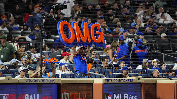 Sep 22, 2024; New York City, New York, USA; A fan holds up an OMG sign during the ninth inning between the Philadelphia Phillies and New York Mets at Citi Field.