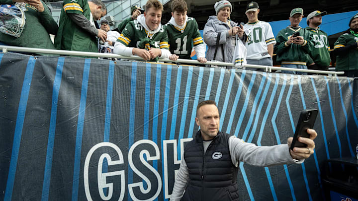 Green Bay Packers defensive coordinator Jeff Hafley does a selfie with fans before their game against the Chicago Bears.