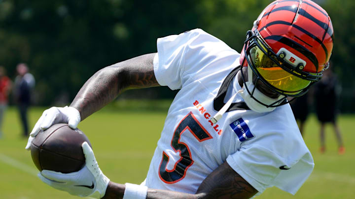 Cincinnati Bengals wide receiver Tee Higgins (5) catches a pass during a session of organized team activities on the Bengals practice field at Paycor Stadium in downtown Cincinnati on Tuesday, June 3, 2025.