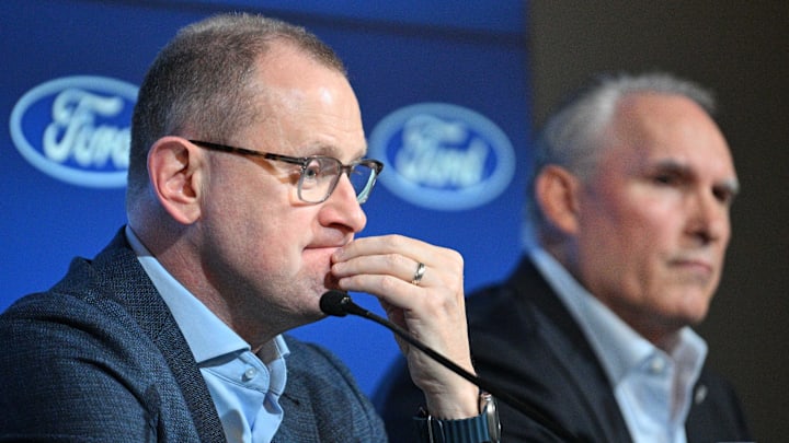Toronto Maple Leafs general manager Brad Treliving listens to a question during a media conference to introduce new head coach Craig Berube (right) at Ford Performance Centre. Mandatory Credit: Dan Hamilton-Imagn Images