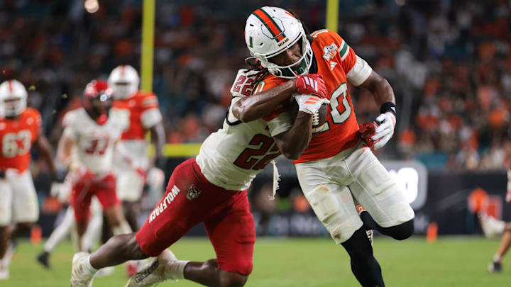 Nov 15, 2025; Miami Gardens, Florida, USA; Miami Hurricanes wide receiver Malachi Toney (10) carries the football against NC State Wolfpack defensive back Jackson Vick (22) during the third quarter at Hard Rock Stadium. Mandatory Credit: Sam Navarro-Imagn Images Nov 15, 2025; Miami Gardens, Florida, USA; Miami Hurricanes wide receiver Malachi Toney (10) carries the football against NC State Wolfpack defensive back Jackson Vick (22) during the third quarter at Hard Rock Stadium. Mandatory Credit: Sam Navarro-Imagn Images