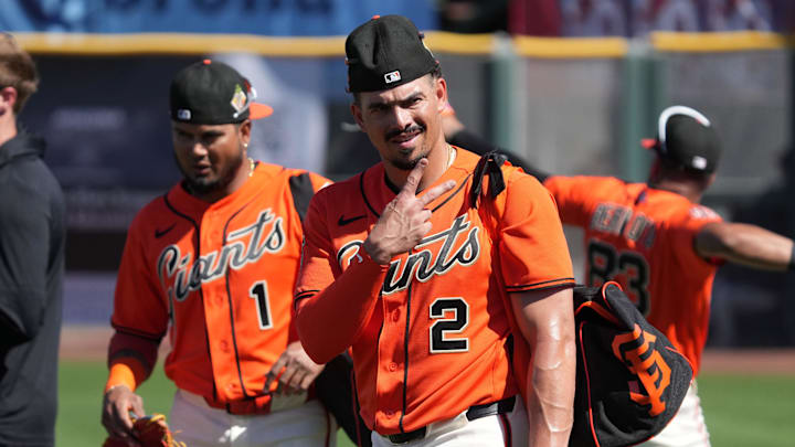 San Francisco Giants shortstop Willy Adames throws up the peace sign with his fingers as he walks off the field. 
